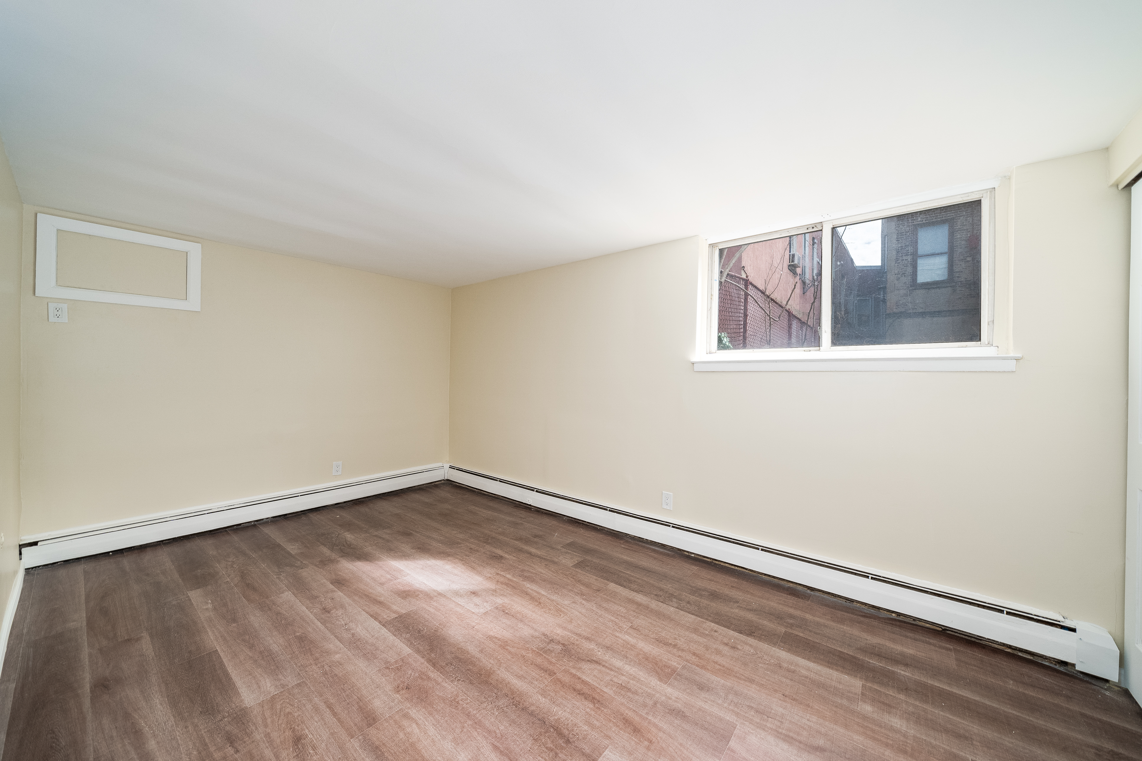 100-108 35th Street Union City, NJ 07087 - Photo 14 of 17 an empty room with wooden floor and windows