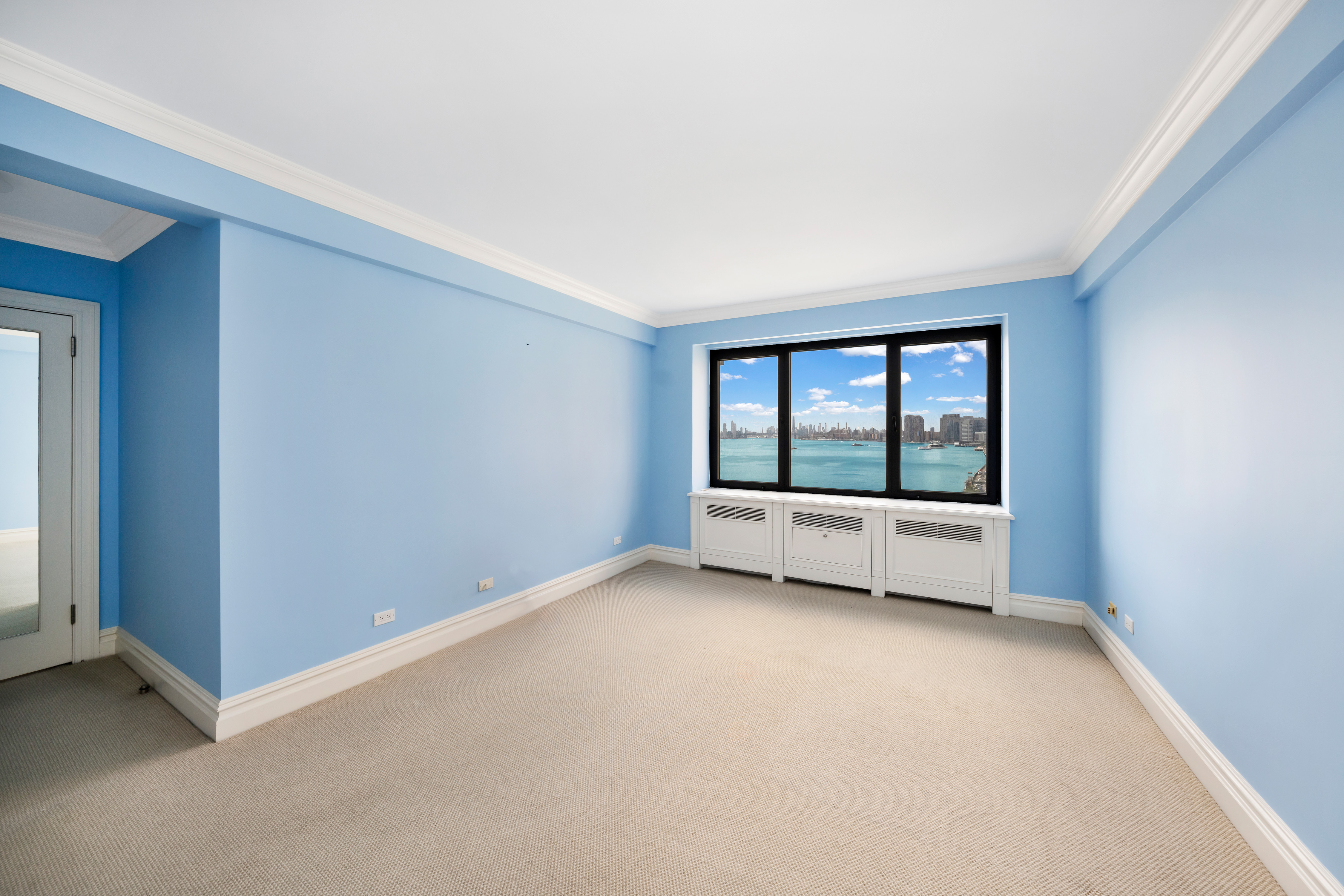 45 Sutton Place South, Unit 8L Manhattan, NY 10022 - Photo 9 of 22 a view of an empty room with a window