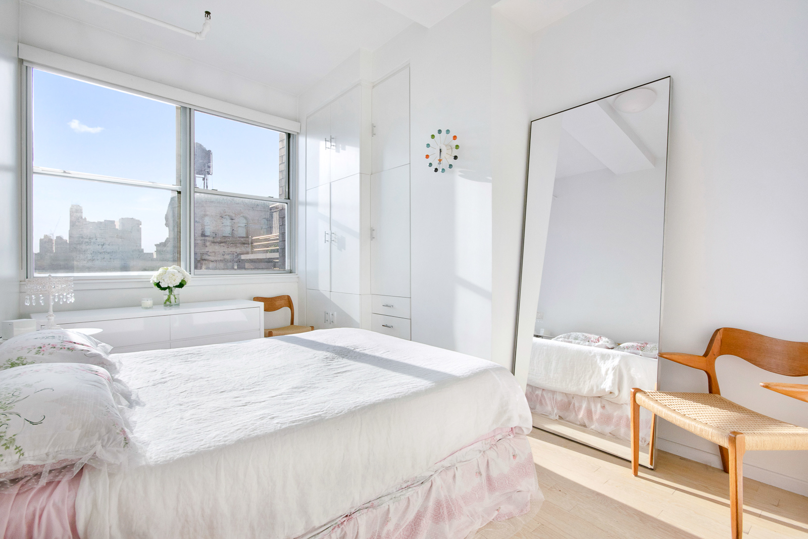 195 Bowery, Unit 7W Manhattan, NY 10002 - Photo 3 of 6 a bedroom with a bed and a large window