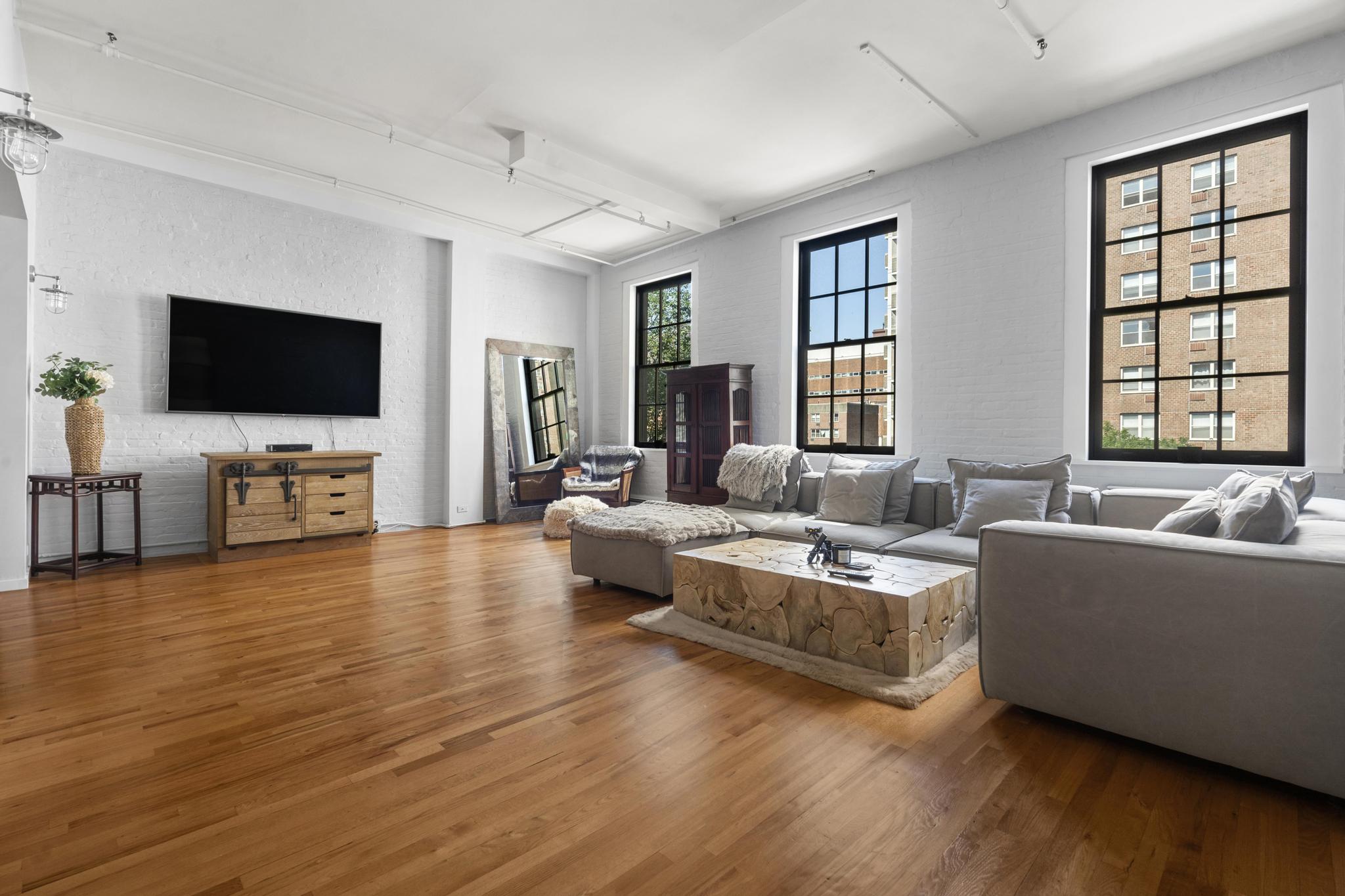 363 Greenwich Street, Unit 3C Manhattan, NY 10013 - Photo 1 of 11 a living room with fireplace furniture and a flat screen tv