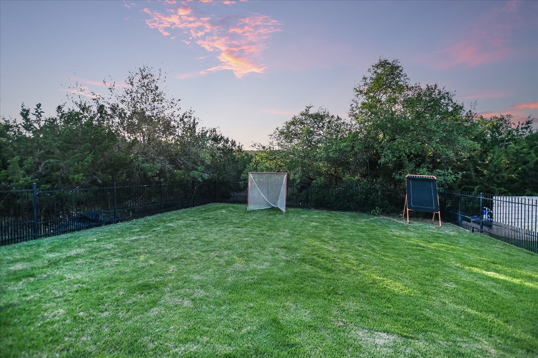 1422 Palomino Ridge Drive Austin, TX 78733 - Photo 54 of 60 a backyard of a house with plants and large trees