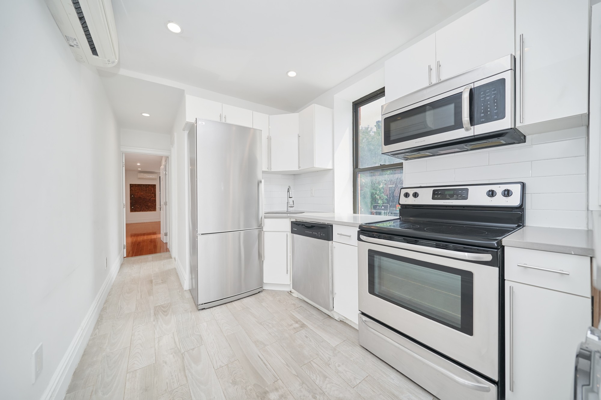 941 Columbus Avenue, Unit 1A Manhattan, NY 10025 - Photo 8 of 14 a kitchen with a stove and a microwave