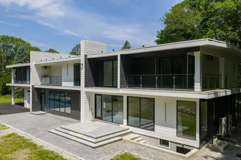 a view of a house with a large window and balcony