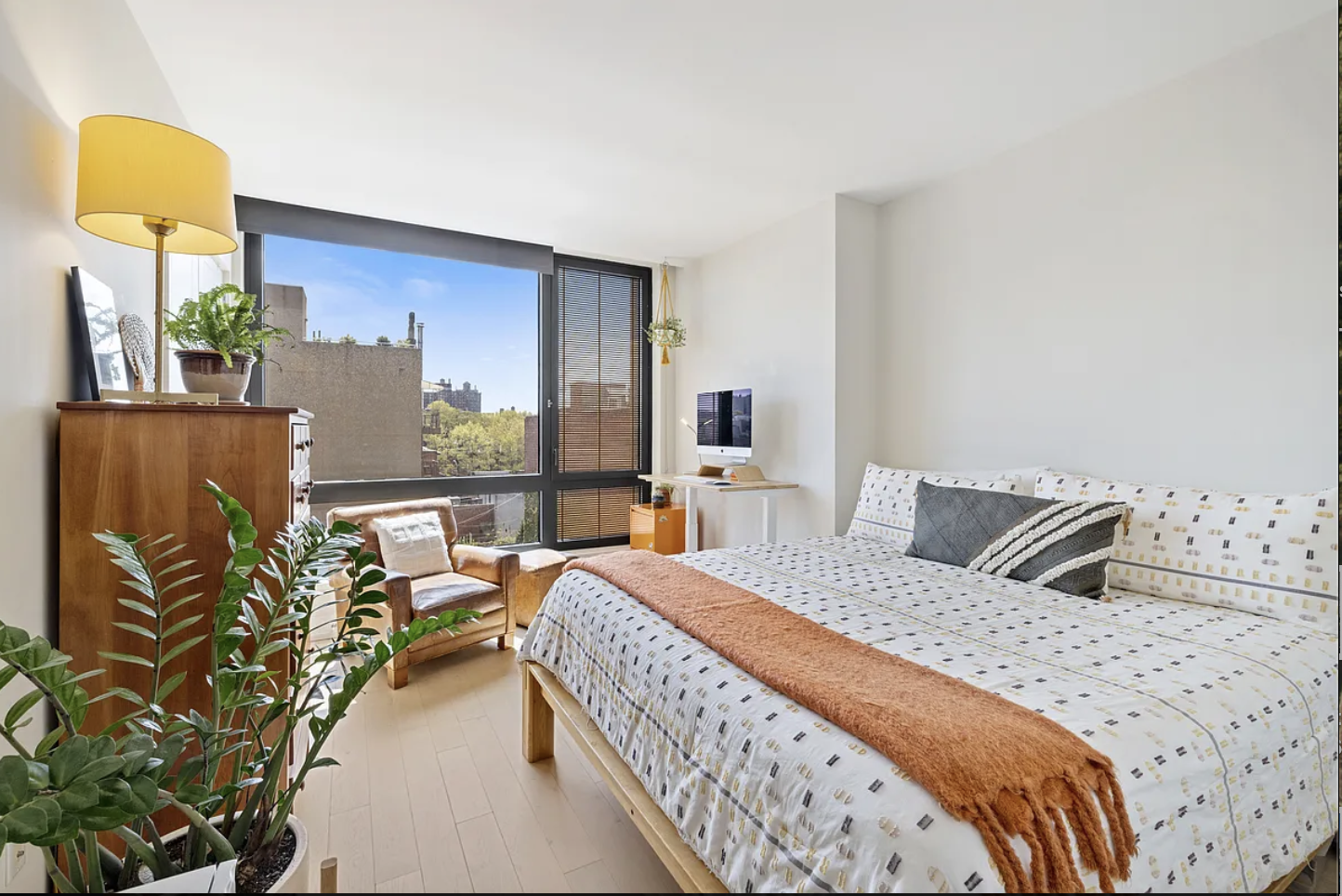 550 Vanderbilt Avenue, Unit 525 Brooklyn, NY 11238 - Photo 6 of 6 a bedroom with a bed lamps and wooden floor