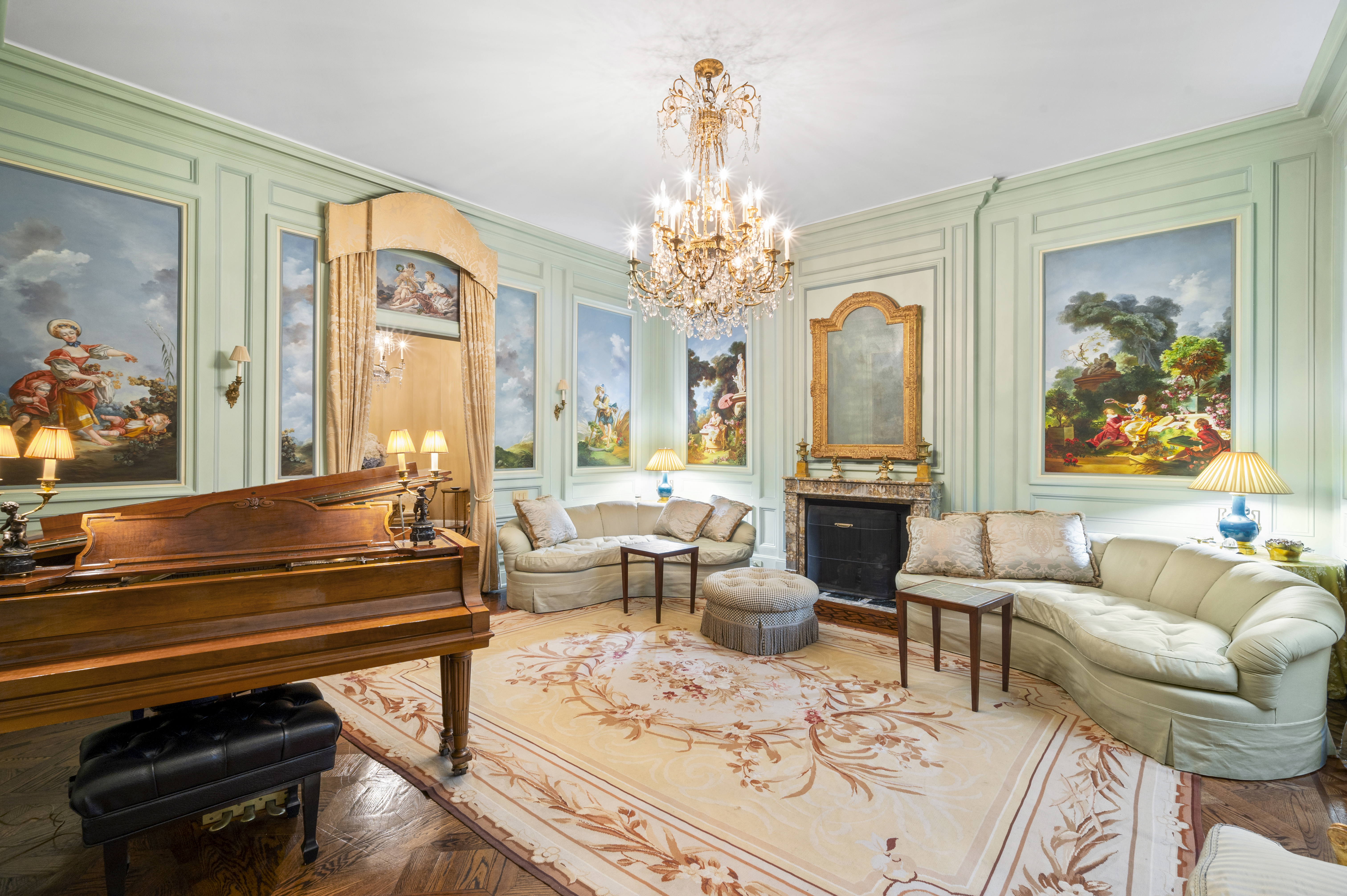163 East 64th Street Manhattan, NY 10065 - Photo 16 of 34 a living room with furniture a fireplace and a chandelier