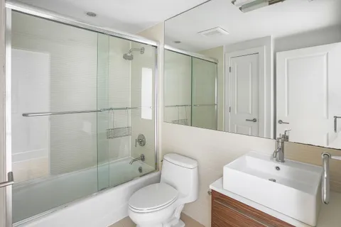 a bathroom with a sink toilet and shower