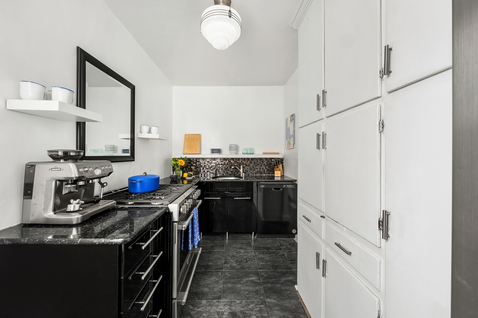 166 West 22nd Street, Unit 6C Manhattan, NY 10011 - Photo 6 of 11 a kitchen with a stove top oven and cabinets
