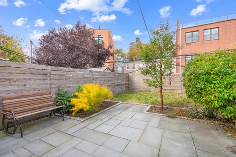 a view of a backyard with sitting area