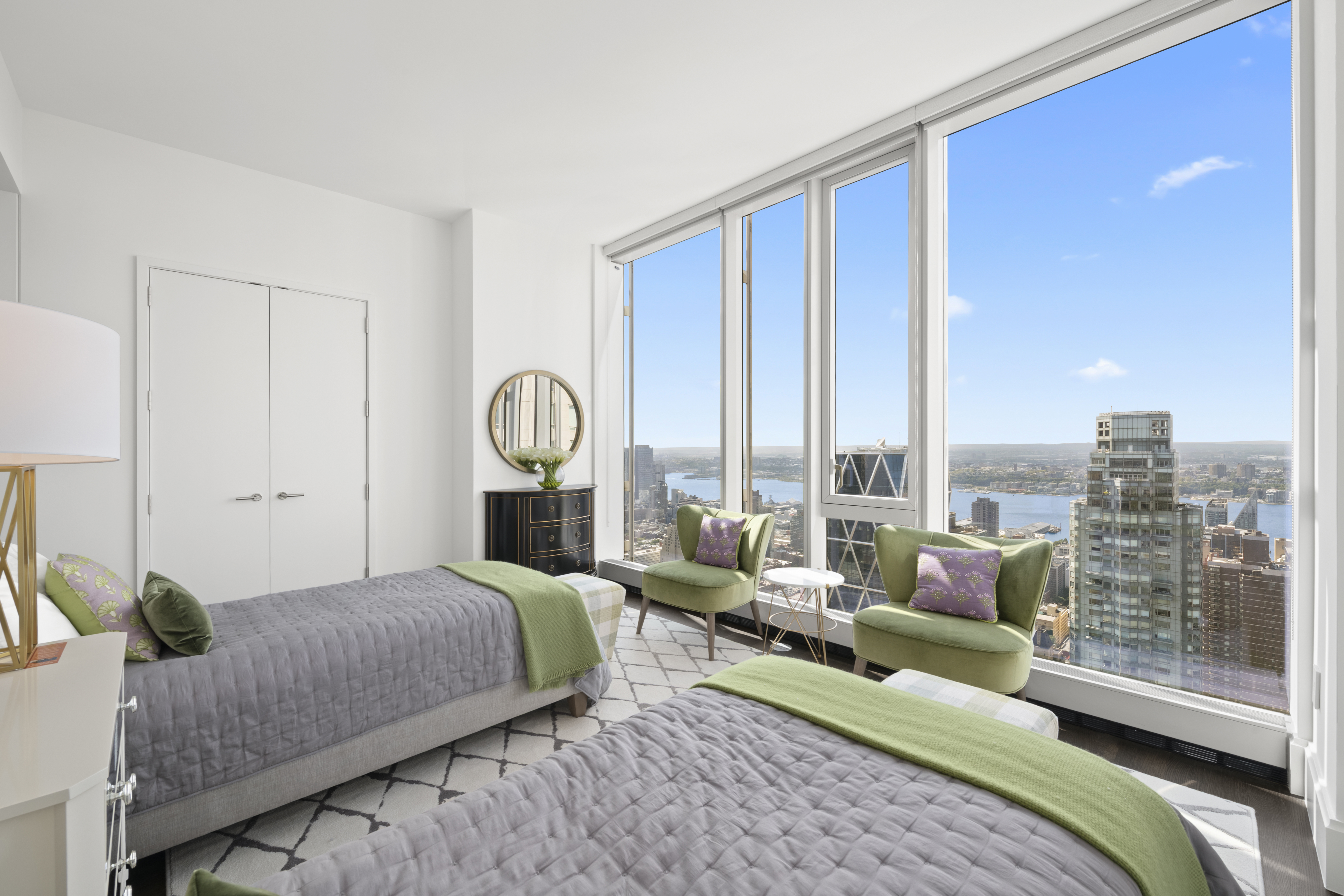 217 West 57th Street, Unit 58W Manhattan, NY 10019 - Photo 9 of 30 a bedroom with a bed large window and walk in closet