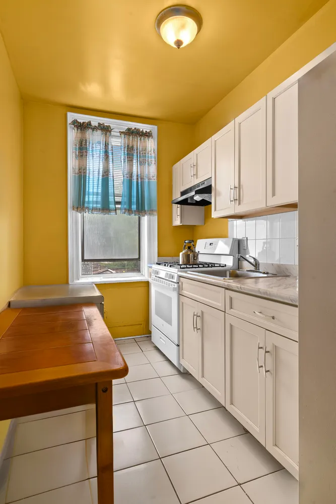 a kitchen with a sink cabinets and window