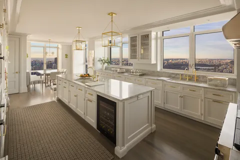 a kitchen with a sink stove and cabinets