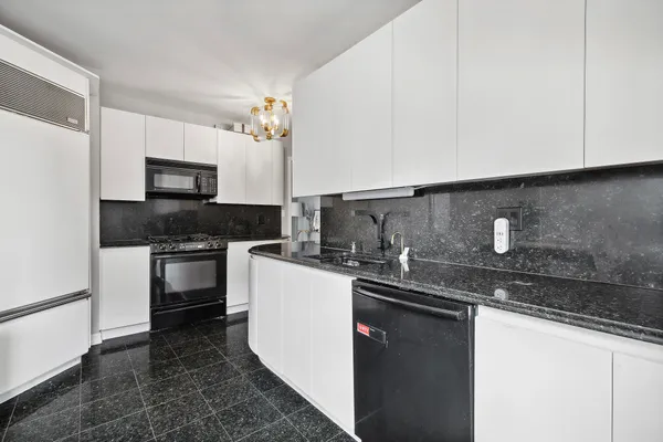 a kitchen with stainless steel appliances granite countertop a sink stove and microwave