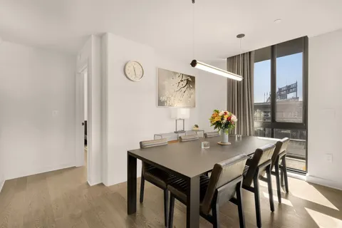a view of a dining room with furniture and window