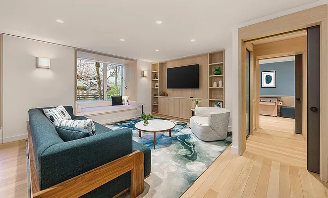 20 River Terrace, Unit 6Q Manhattan, NY 10282 - Photo 7 of 20 a living room with furniture and a flat screen tv