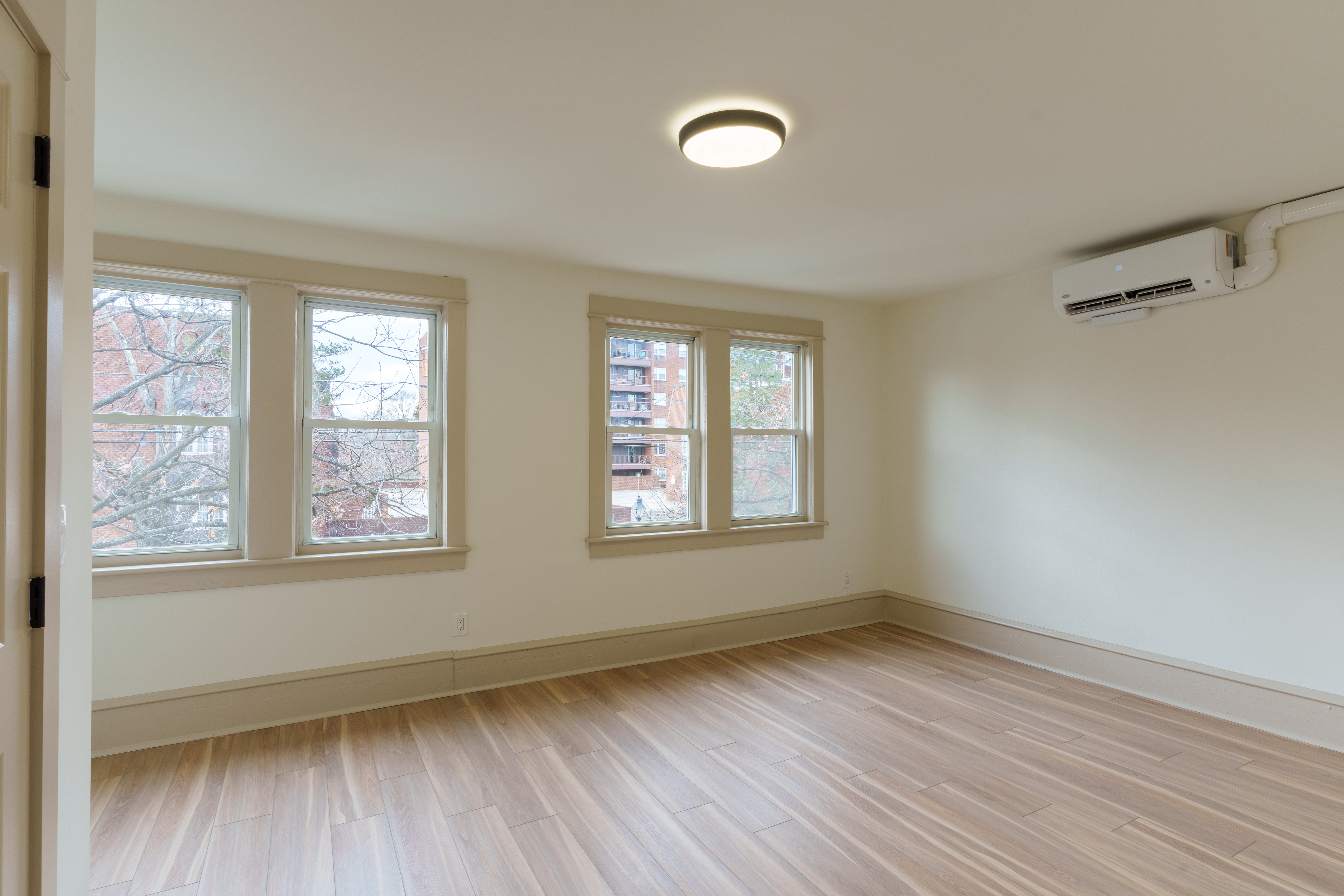 423 North Haddon Avenue Haddonfield, NJ 08033 - Photo 9 of 16 a view of an empty room with wooden floor and a window