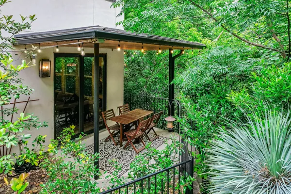 a backyard of a house with table and chairs