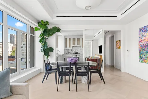 a view of a dining room with furniture and window