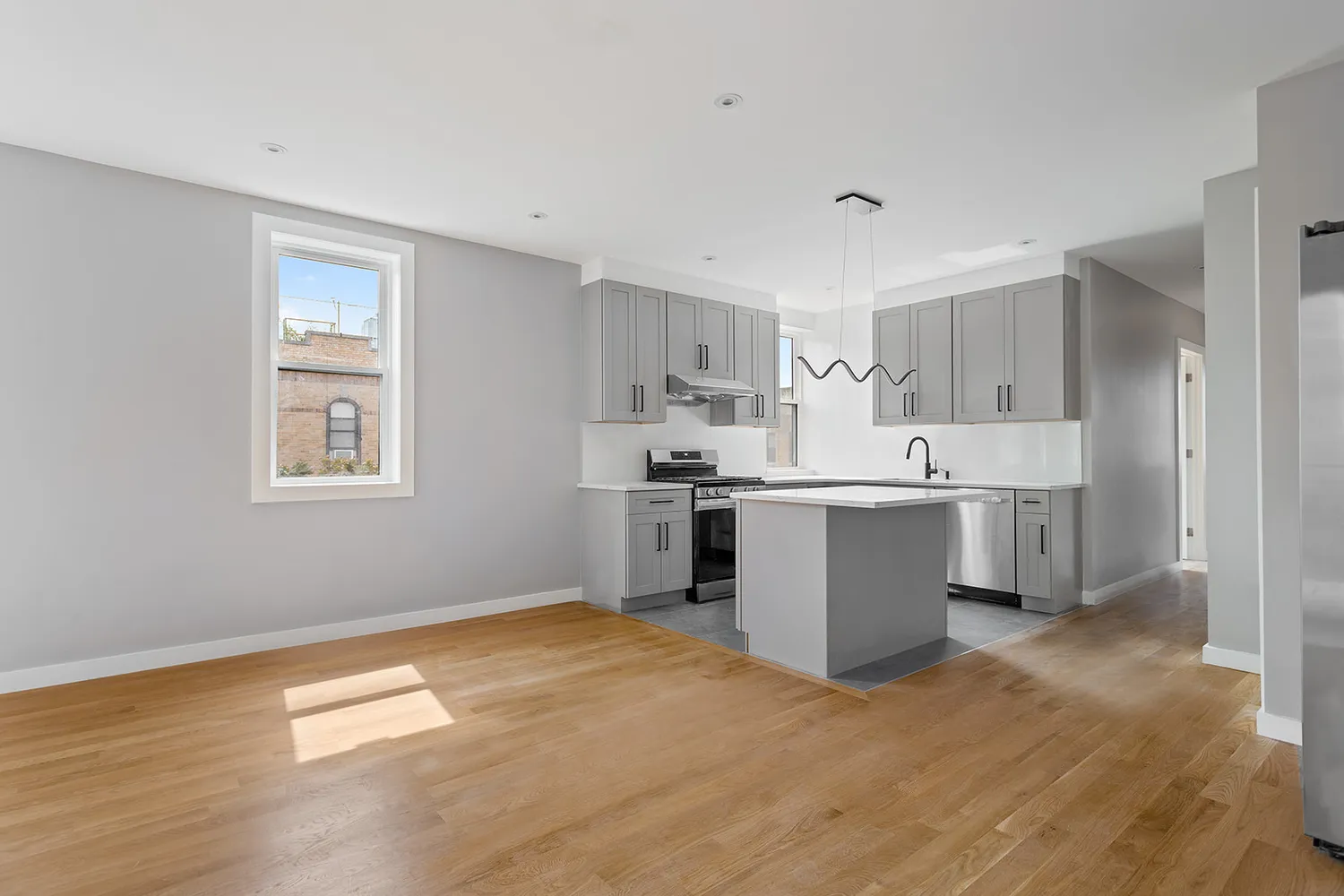 a kitchen with a sink cabinets and wooden floor