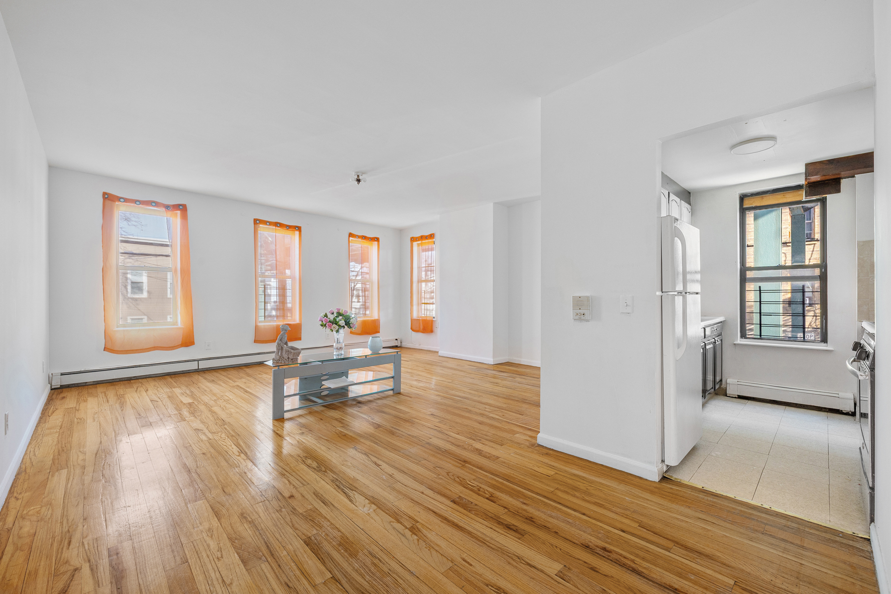106 Crescent Street Brooklyn, NY 11208 - Photo 9 of 18 a living room with furniture and wooden floor