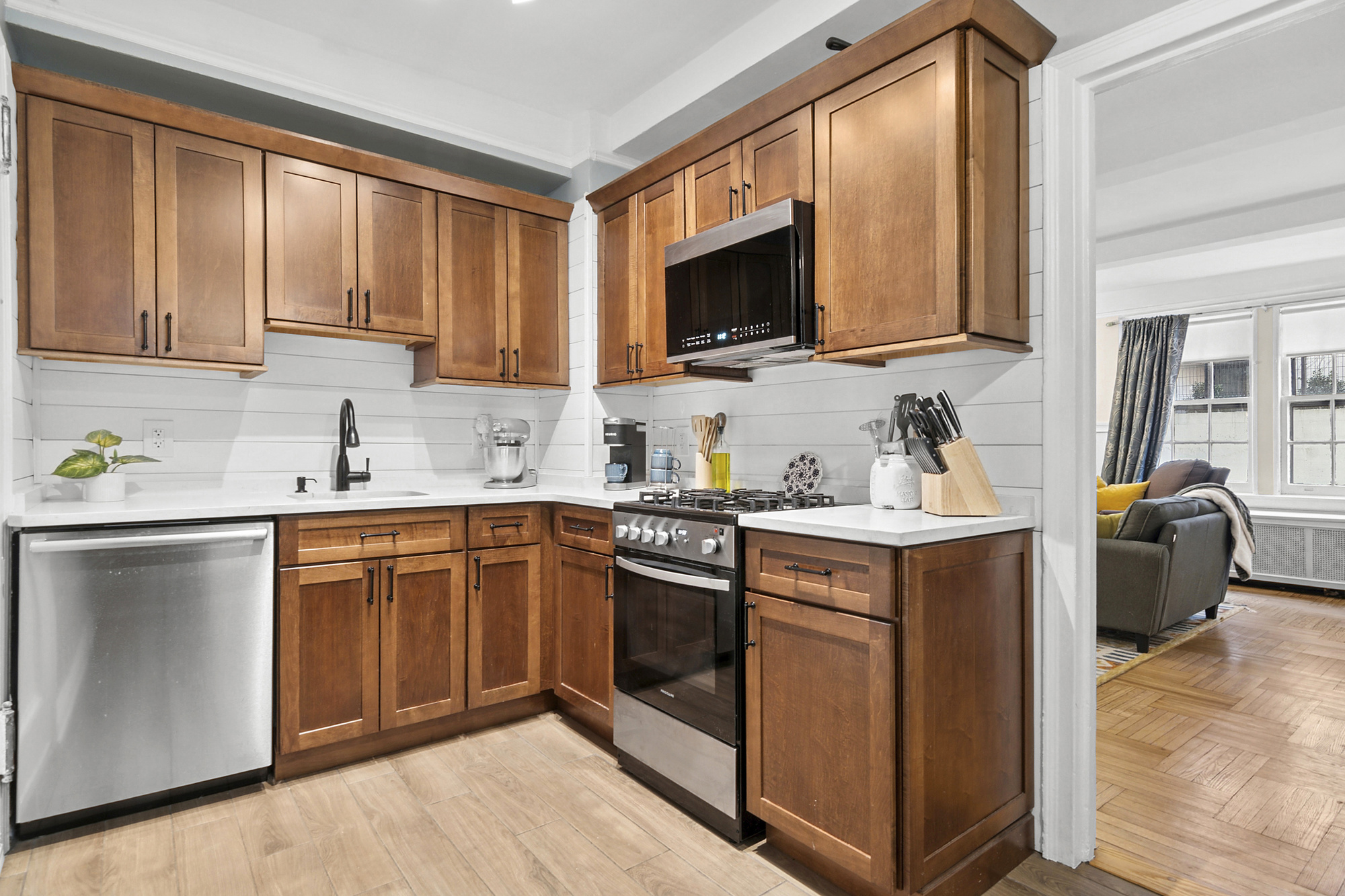 24 Monroe Place, Unit 1C Brooklyn, NY 11201 - Photo 2 of 10 a kitchen with stainless steel appliances granite countertop white cabinets a sink and a stove