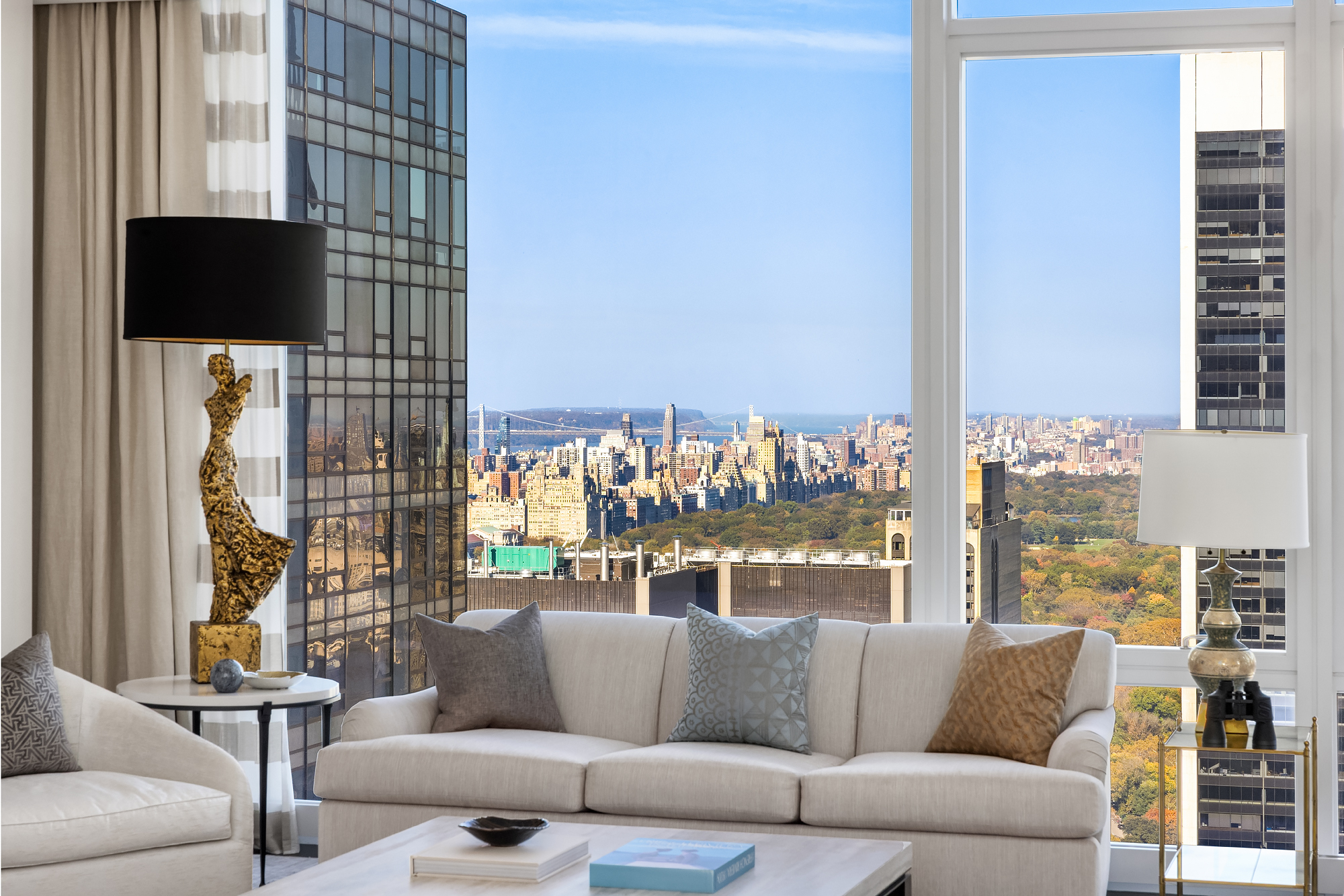 20 West 53rd Street, Unit 45A Manhattan, NY 10019 - Photo 1 of 10 a living room with furniture and a floor to ceiling window