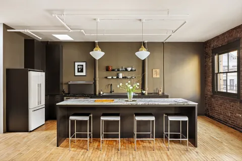 a kitchen with stainless steel appliances granite countertop a sink and a refrigerator