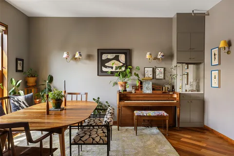 a view of a dining room with furniture and chandelier