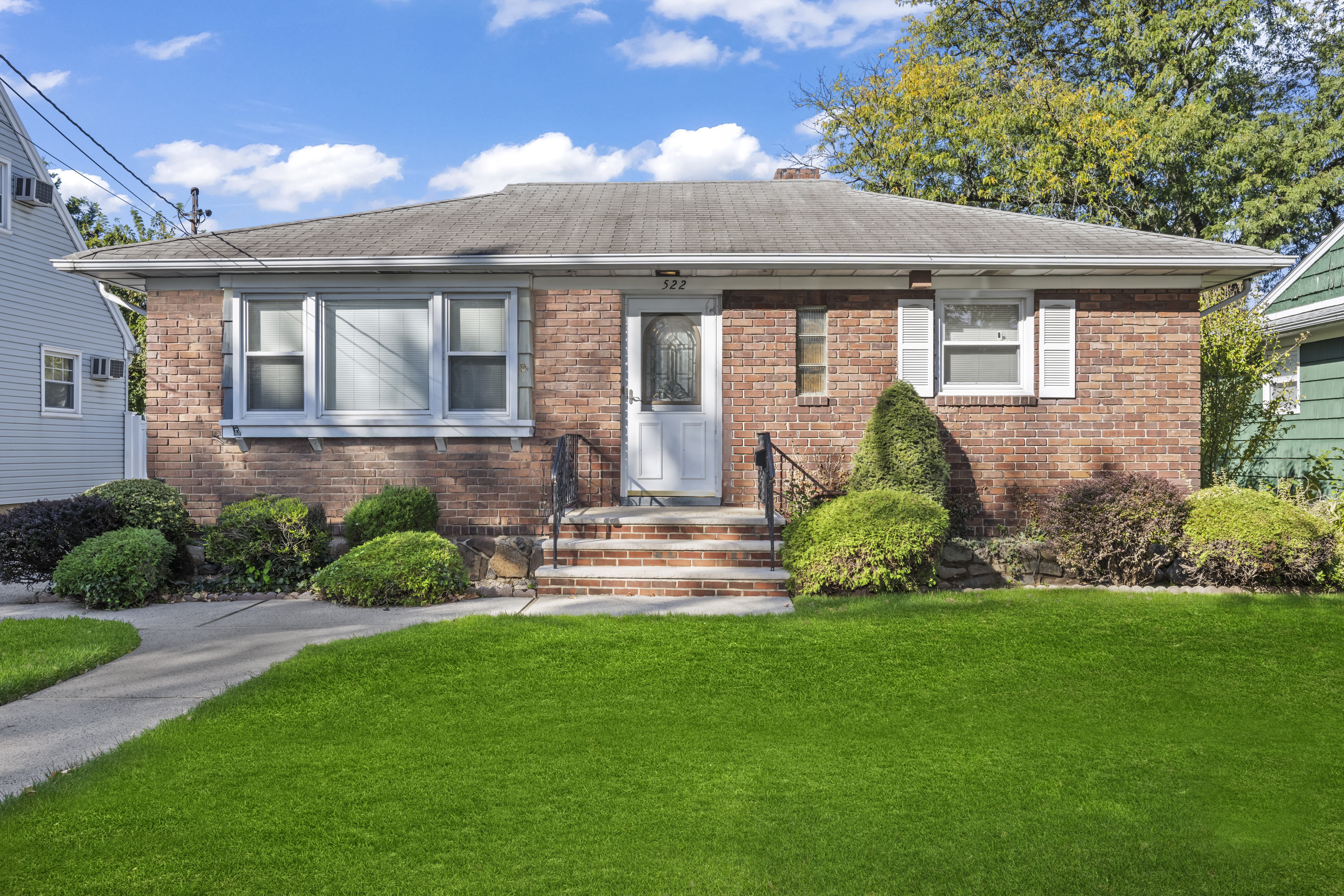 522 Stewart Avenue Staten Island, NY 10314 - Photo 2 of 33 a front view of a house with a yard and outdoor seating