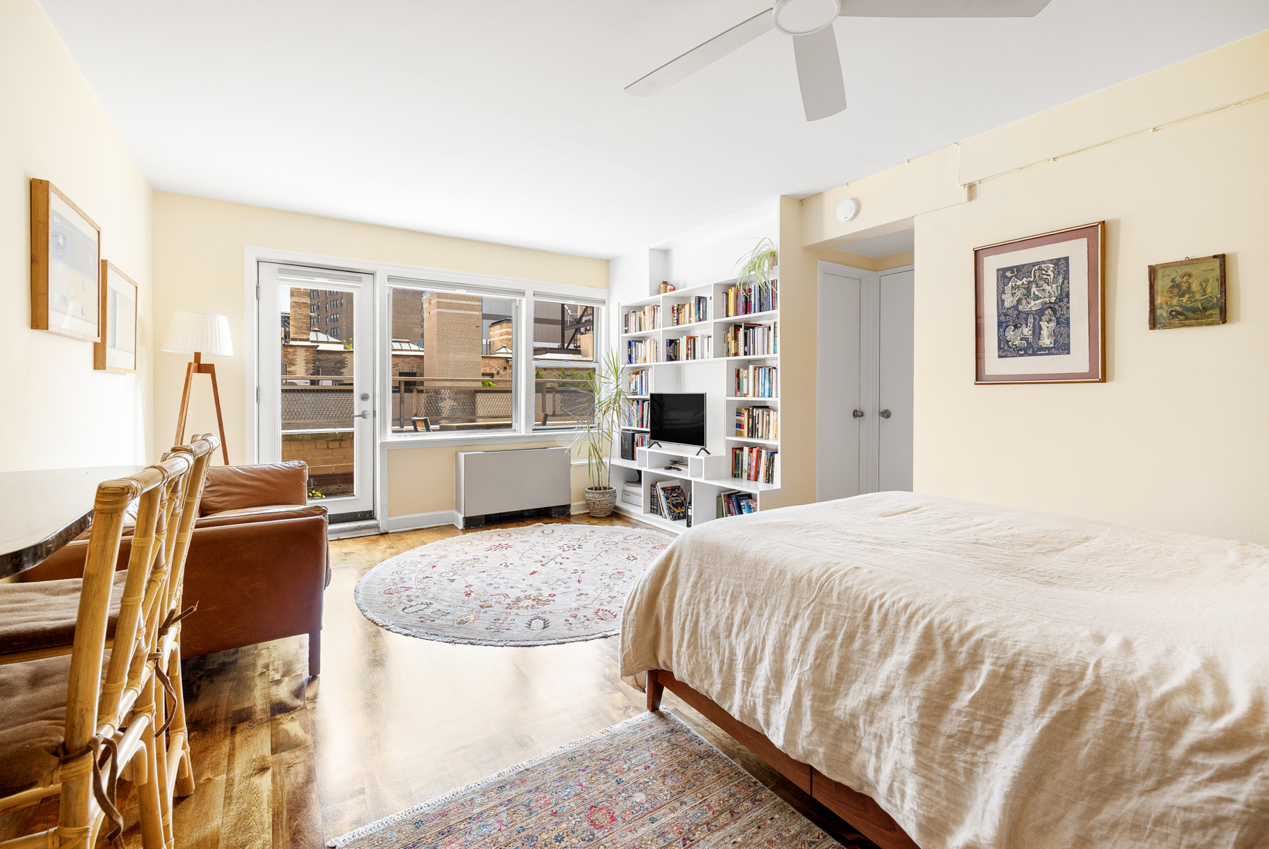 55 East 9th Street, Unit 12H Manhattan, NY 10003 - Photo 5 of 9 a spacious bedroom with a bed and glass door