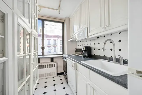 a kitchen with a sink stove and cabinets
