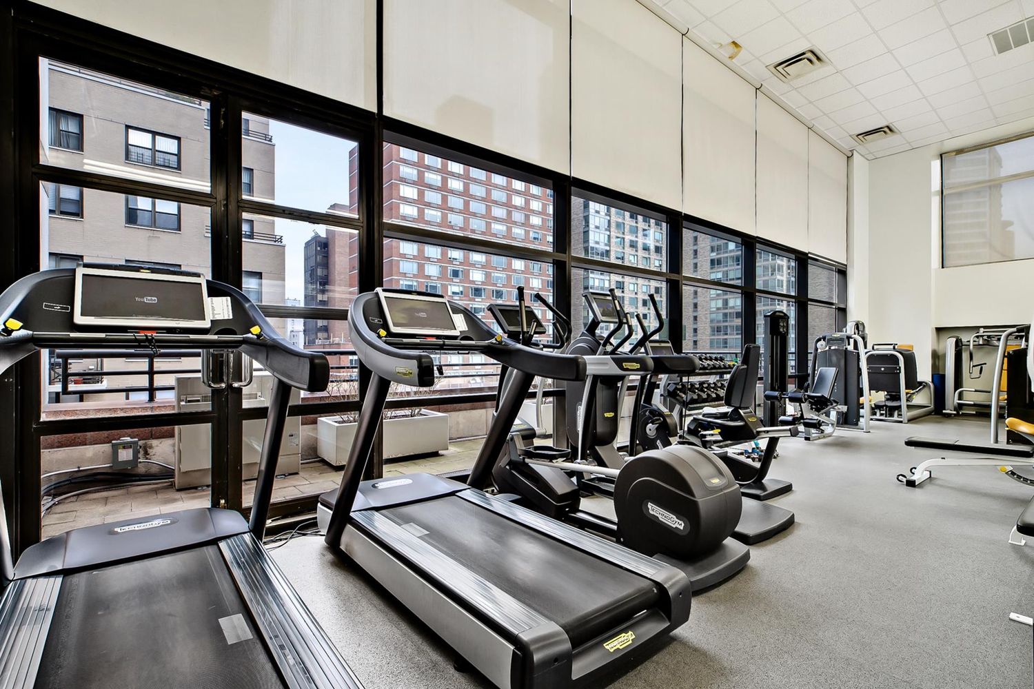 160 West 66th Street, Unit 23D Manhattan, NY 10023 - Photo 7 of 10 a room with gym equipment