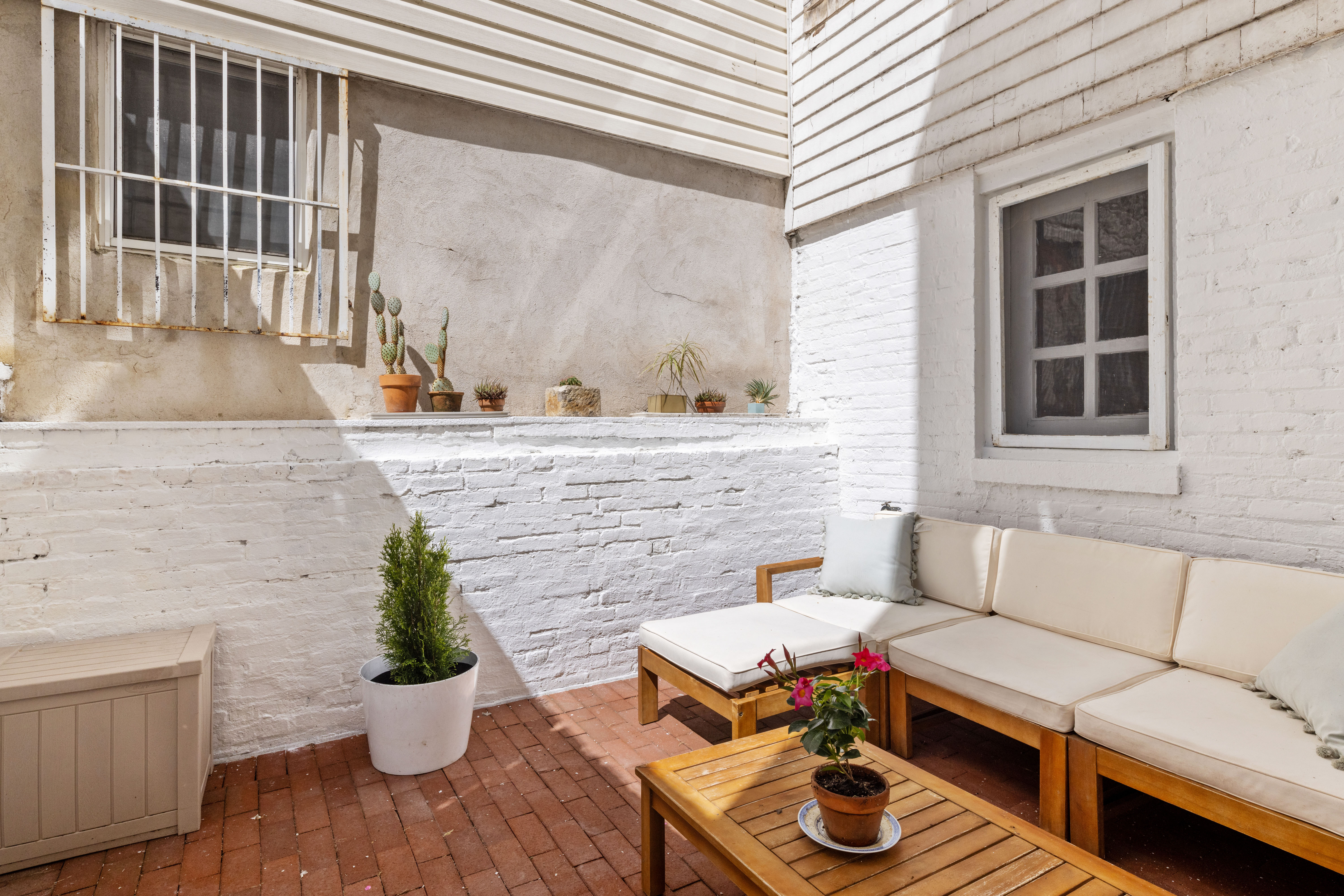 61 Norman Avenue Brooklyn, NY 11222 - Photo 19 of 22 a living room with furniture and a potted plant