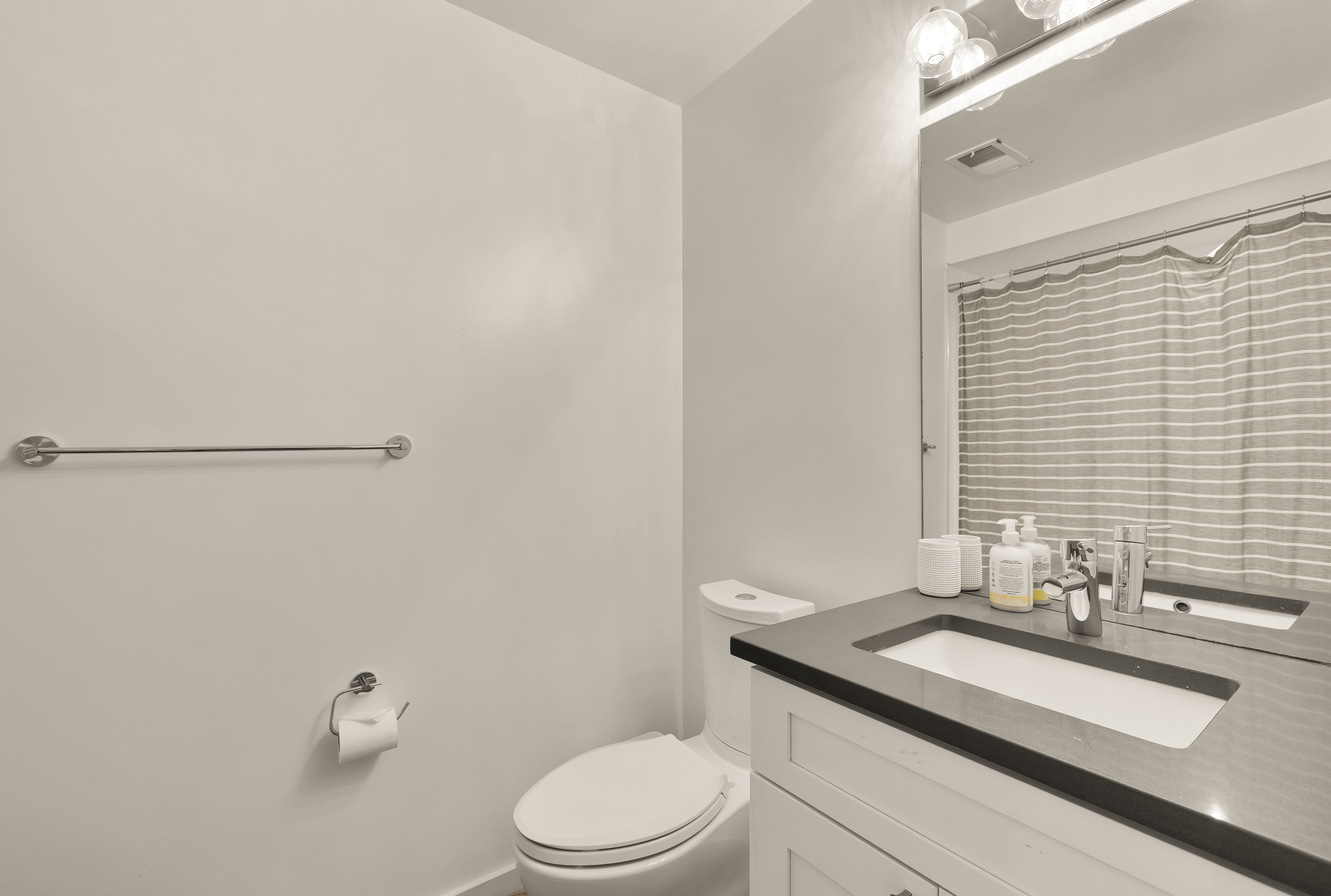 2710 Brandywine Street Northwest Washington, DC 20008 - Photo 62 of 74 a bathroom with a granite countertop sink a toilet and a mirror