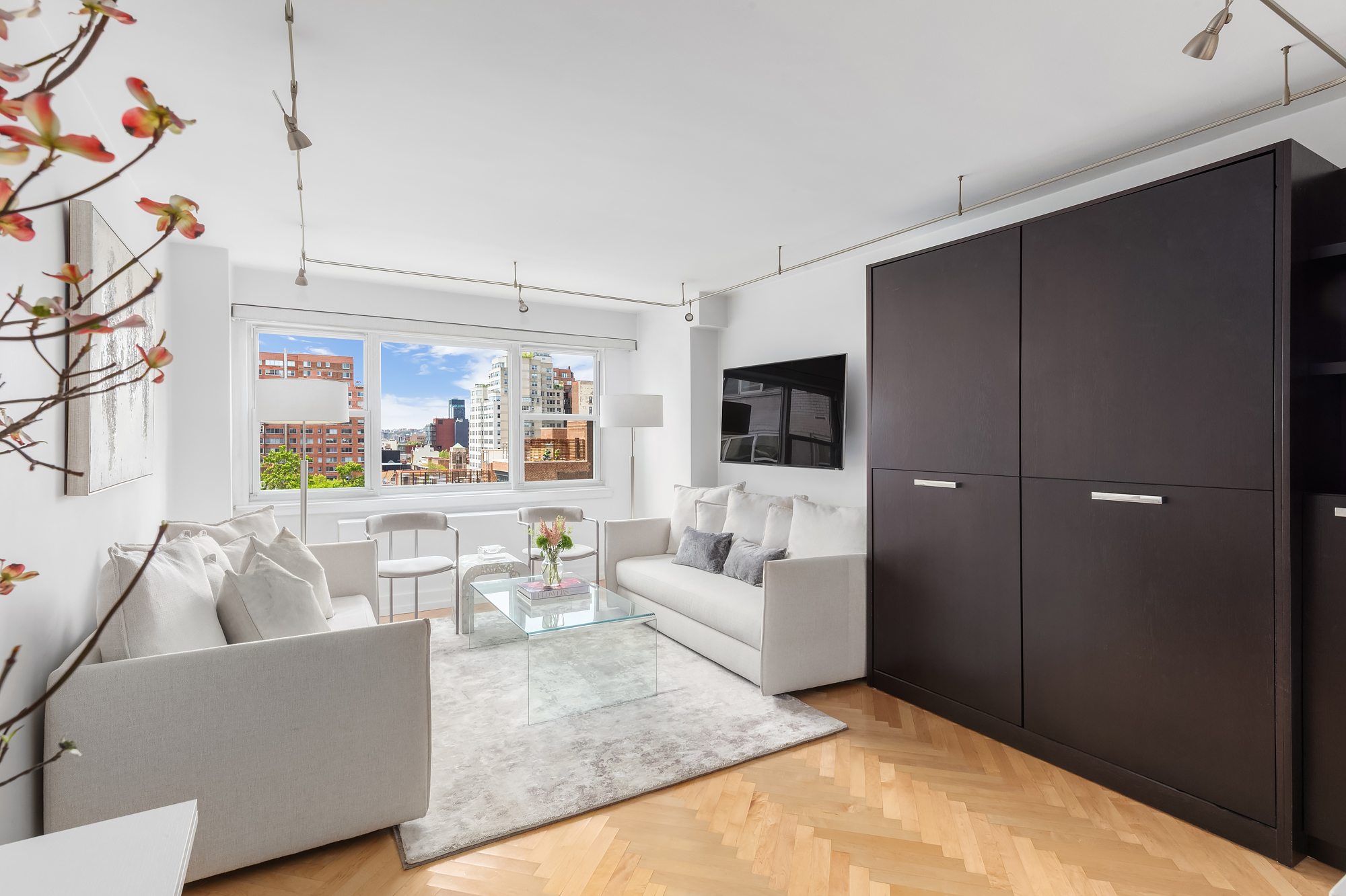 101 West 12th Street, Unit 12B Manhattan, NY 10011 - Photo 6 of 10 a living room with furniture and a flat screen tv