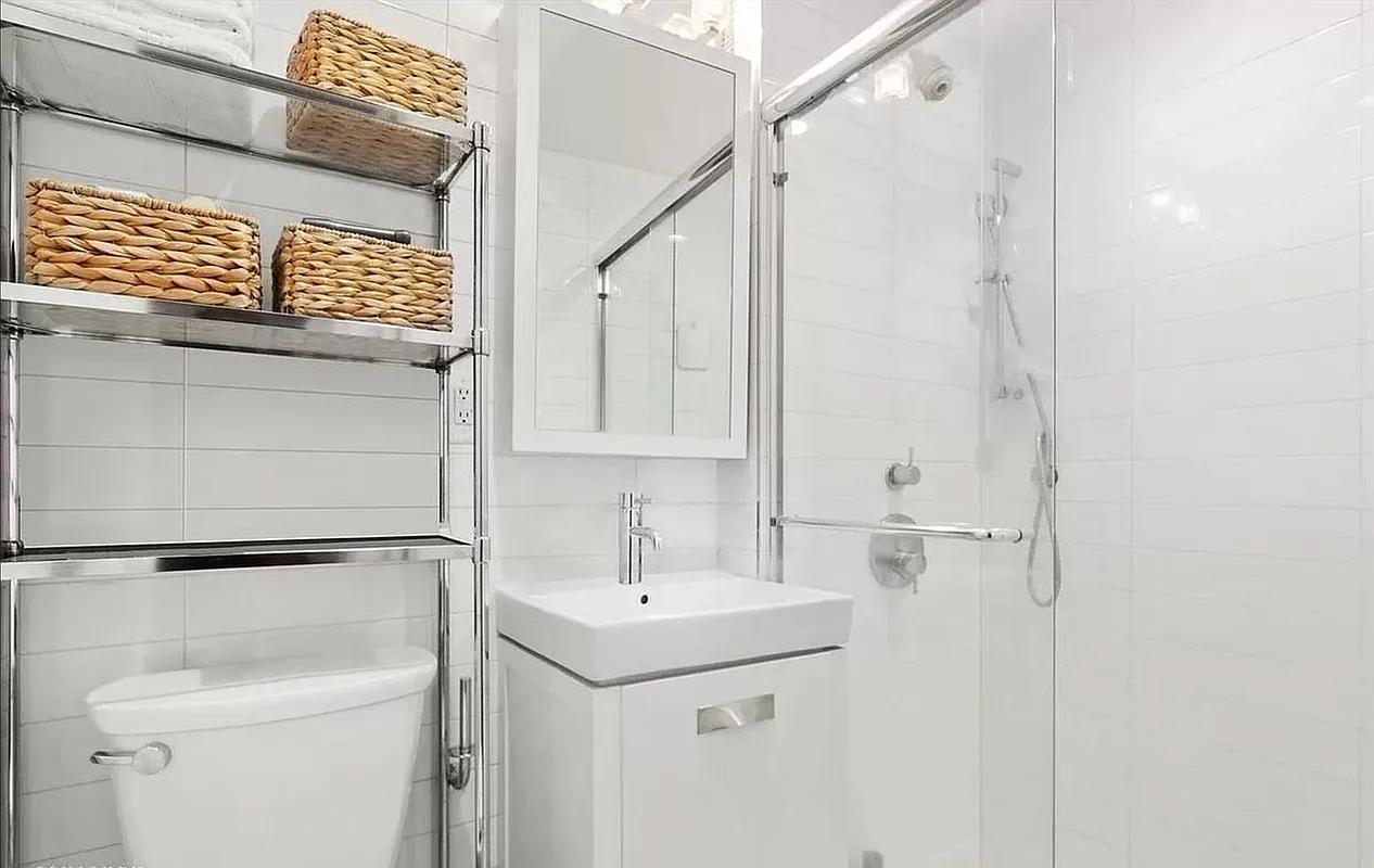 228 East 81st Street, Unit 7A Manhattan, NY 10028 - Photo 5 of 7 a bathroom with a sink a toilet and shower