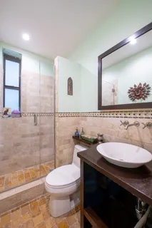 a bathroom with a sink a toilet and shower