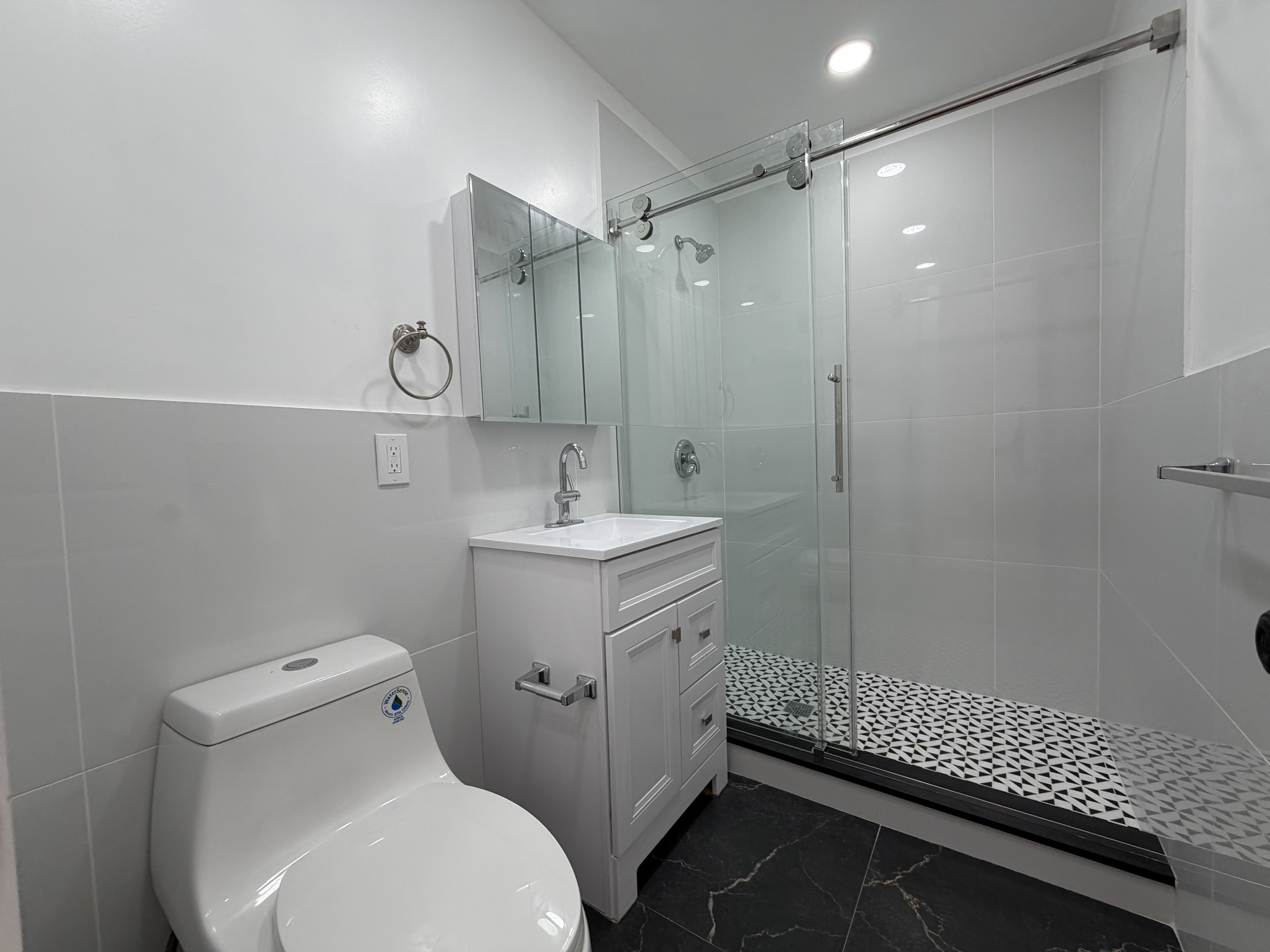 18-61 Dekalb Avenue, Unit 1 Queens, NY 11385 - Photo 7 of 12 a bathroom with a sink toilet and shower