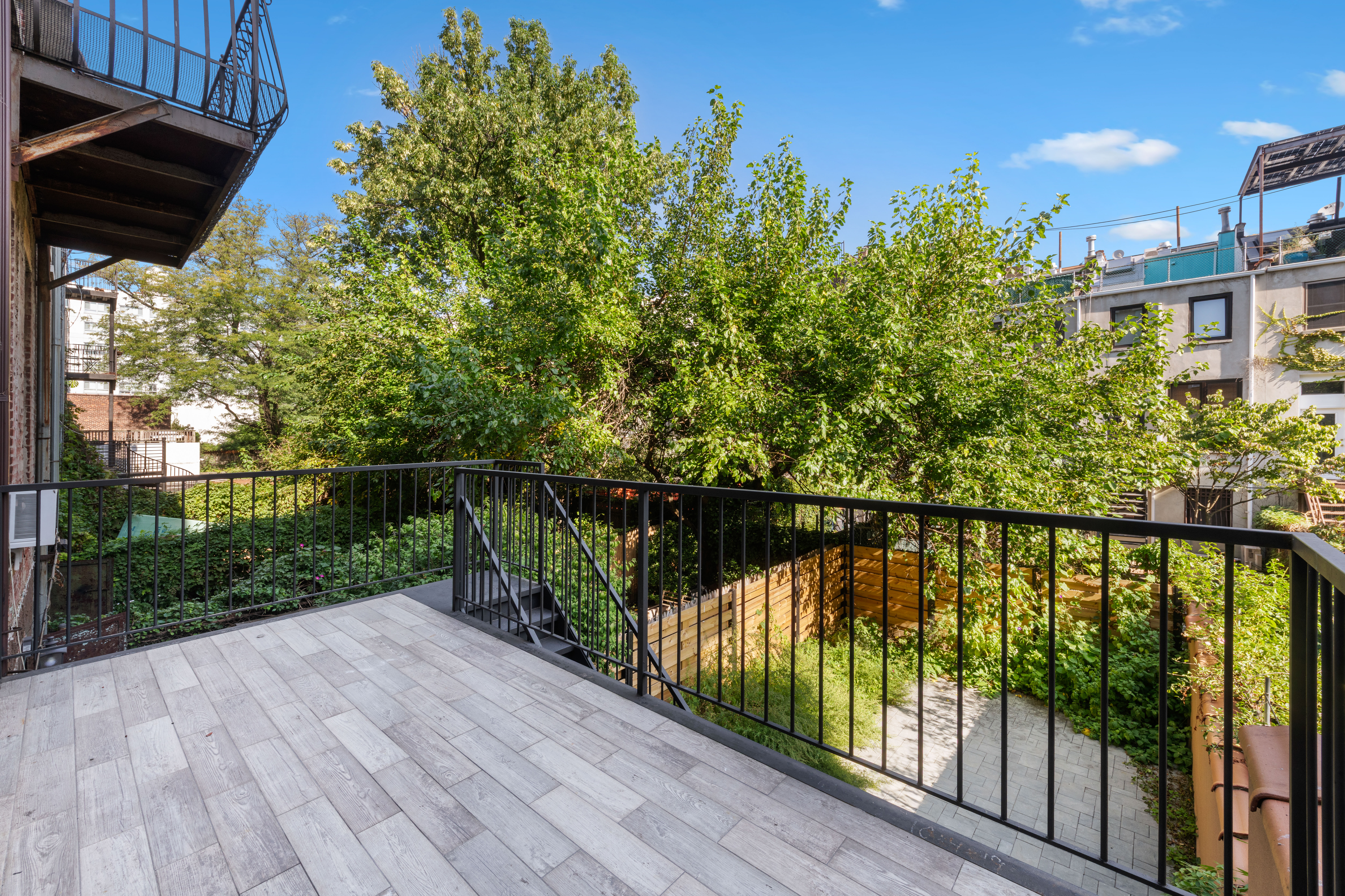 129 West 131st Street, Unit 1 Manhattan, NY 10027 - Photo 7 of 15 a view of a balcony with wooden floor