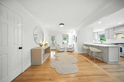 a large living room with stainless steel appliances granite countertop a couch counter space and a view of living room