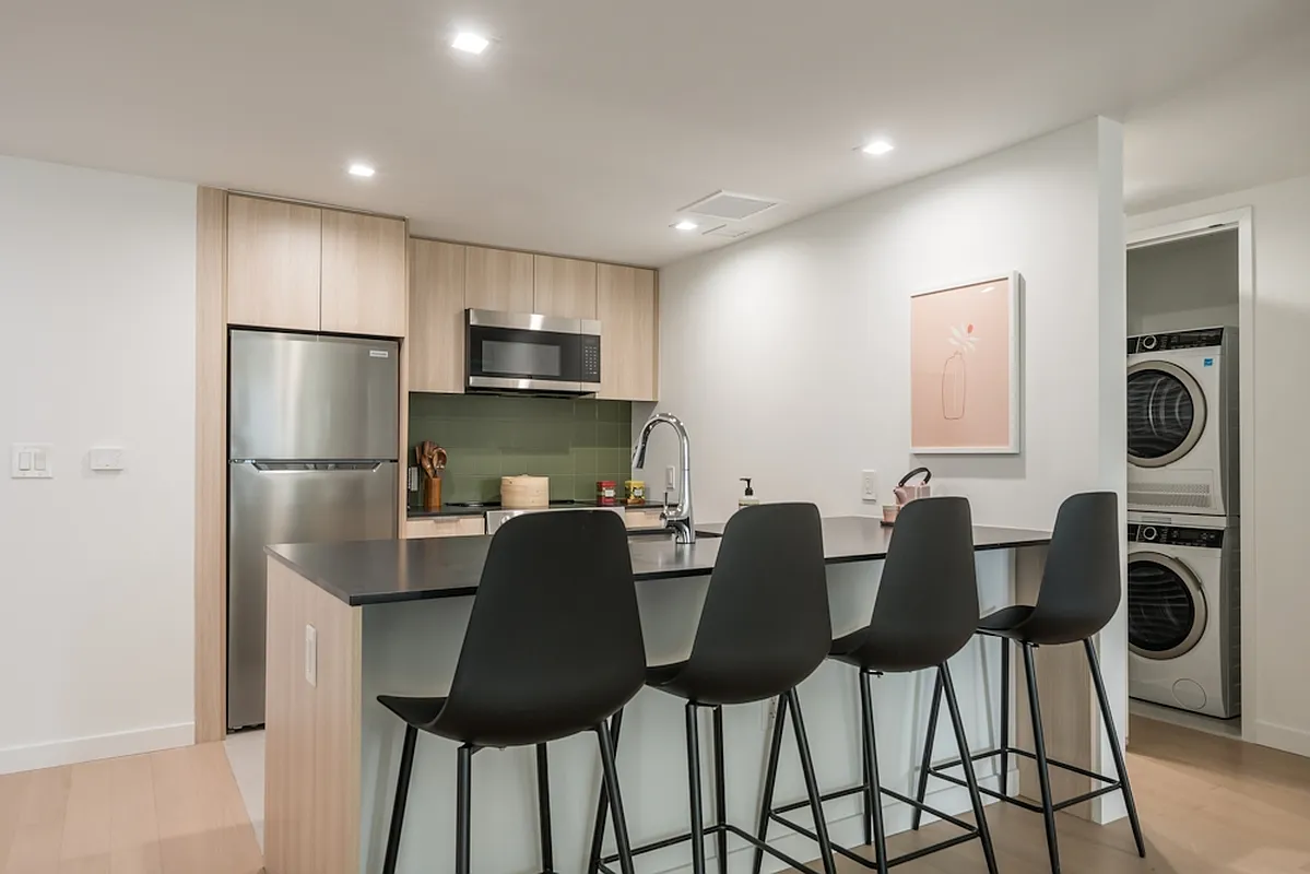 975 Nostrand Avenue, Unit 241 Brooklyn, NY 11225 - Photo 2 of 18 a kitchen with stainless steel appliances granite countertop a refrigerator and a stove top oven