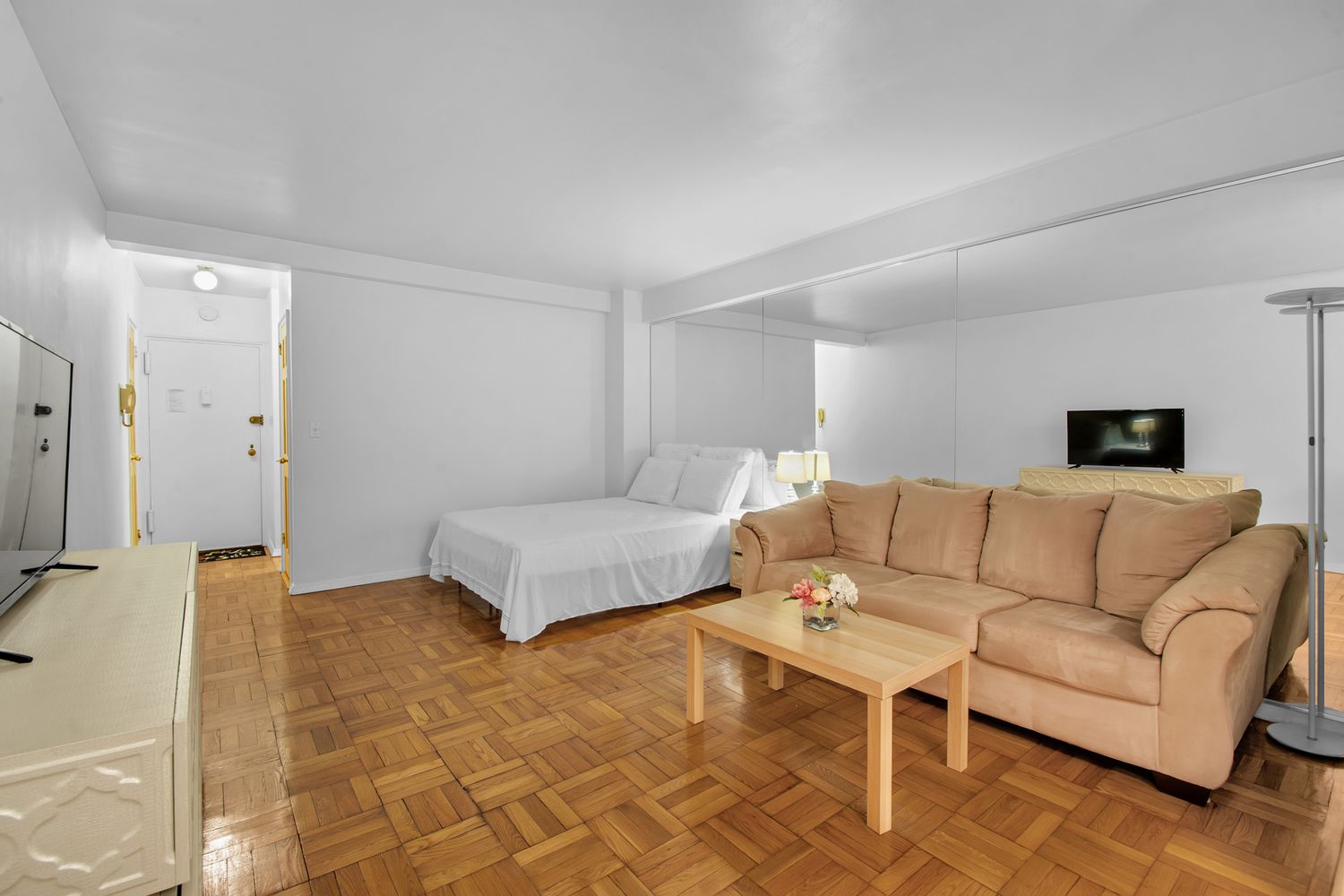 225 East 46th Street, Unit 4K Manhattan, NY 10017 - Photo 3 of 14 a living room with furniture and a couch