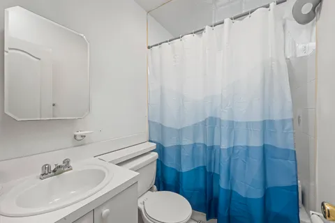 a bathroom with a sink toilet and shower
