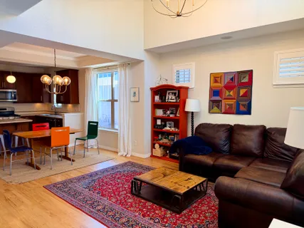 a living room with furniture a rug and a table