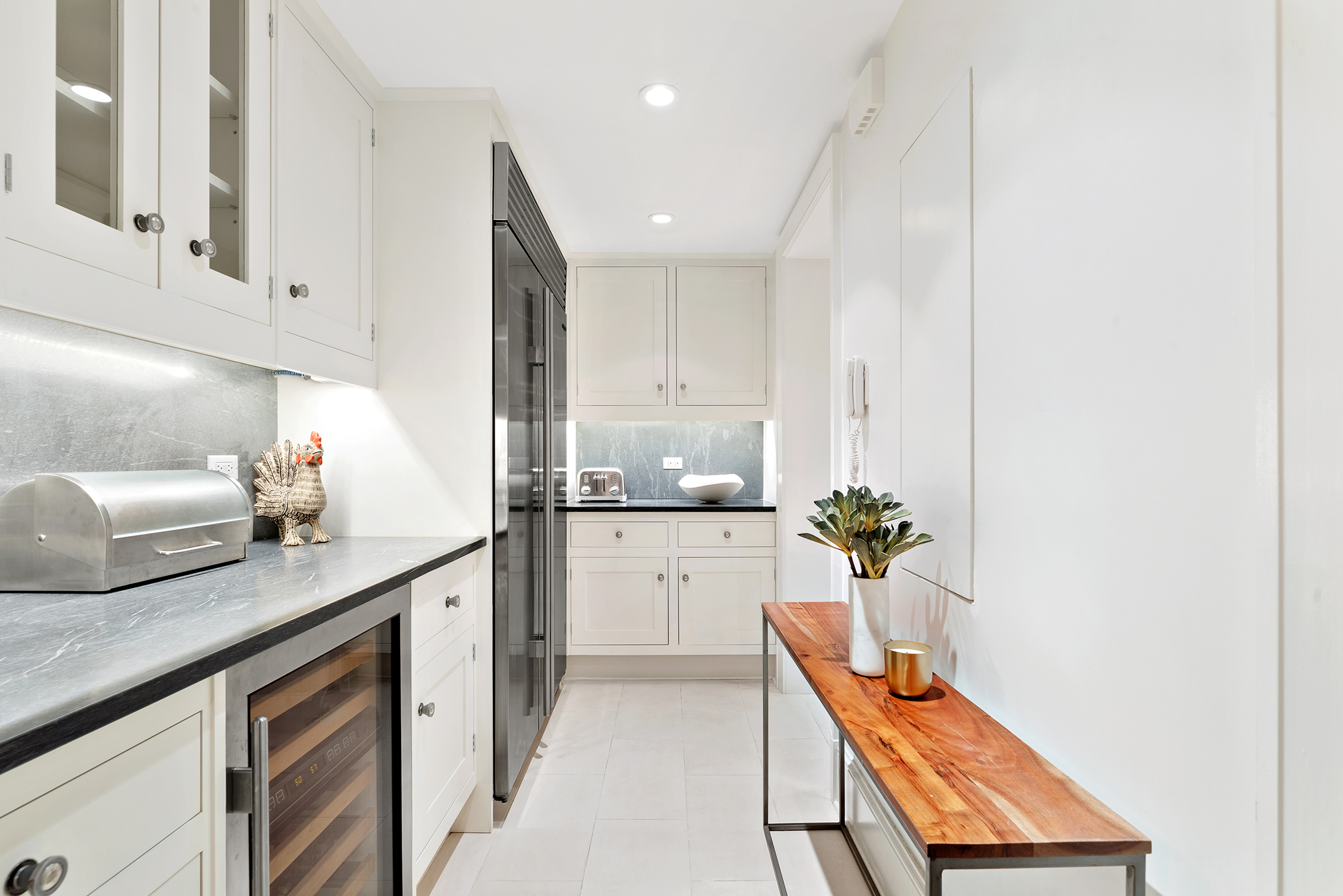 530 Park Avenue, Unit 2F Manhattan, NY 10065 - Photo 8 of 19 a kitchen with white cabinets and counter space
