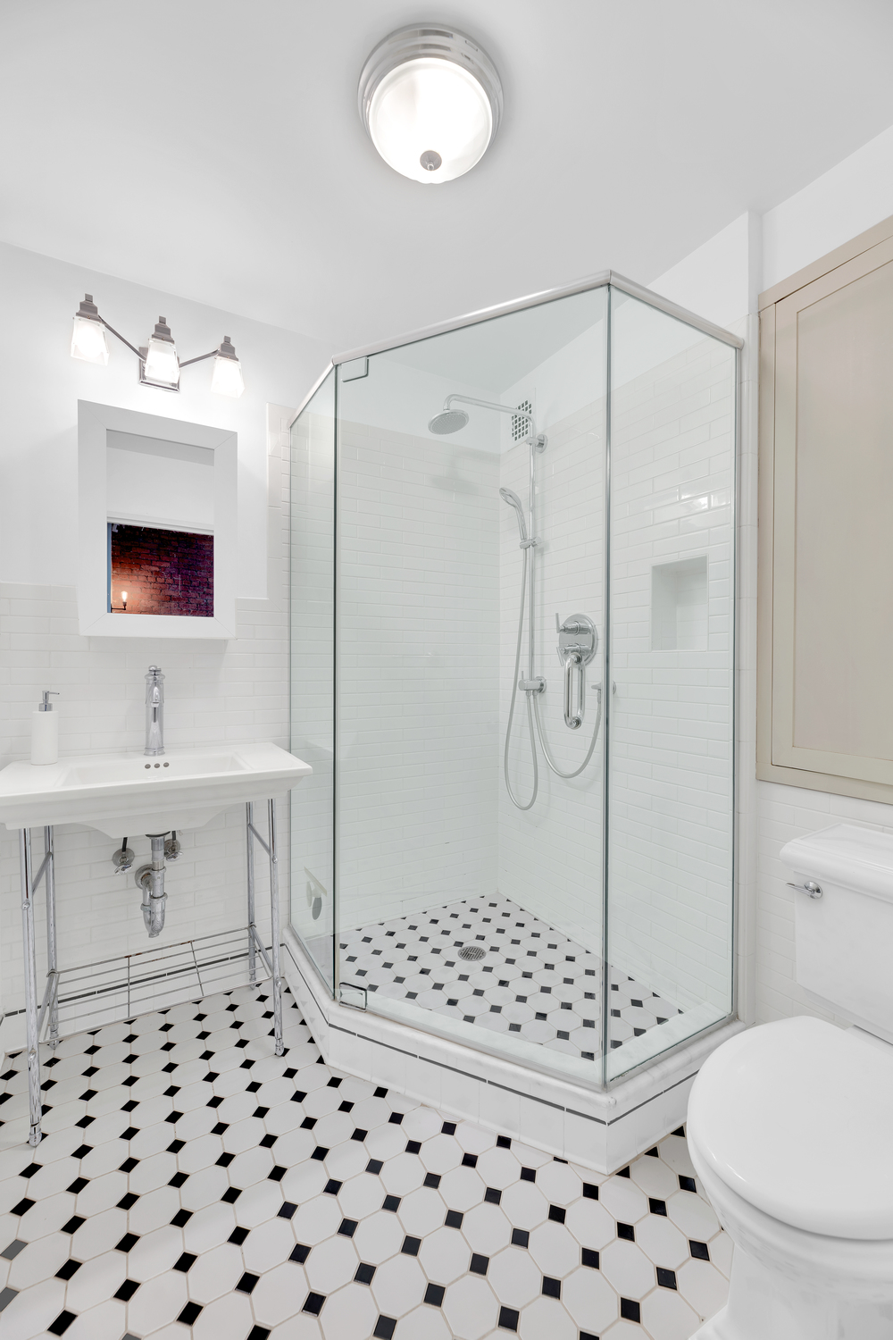 23 East 10th Street, Unit 321 Manhattan, NY 10003 - Photo 4 of 10 a bathroom with a sink toilet and shower