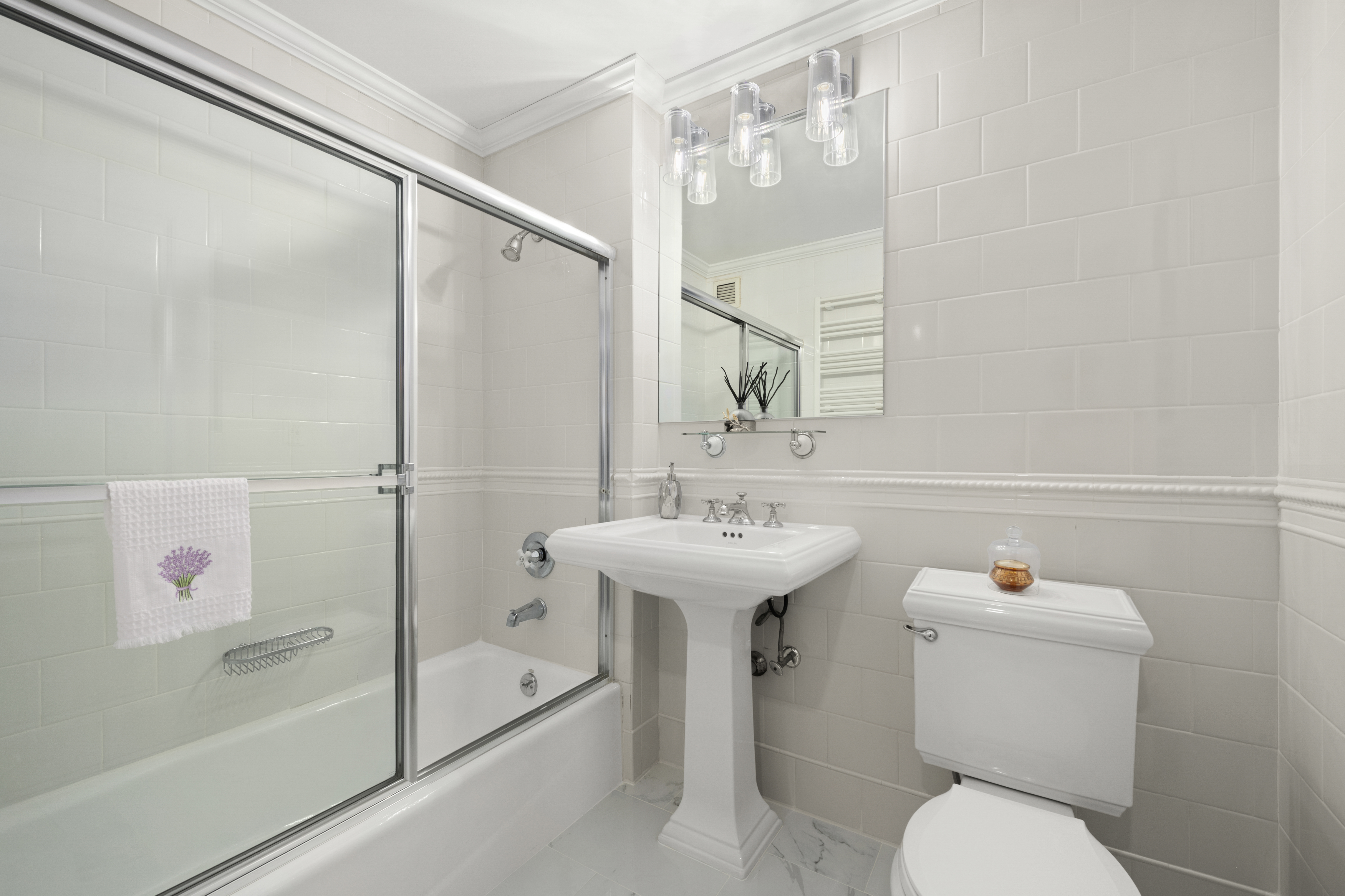 404 East 76th Street, Unit 17A Manhattan, NY 10021 - Photo 10 of 18 a bathroom with a sink toilet and shower