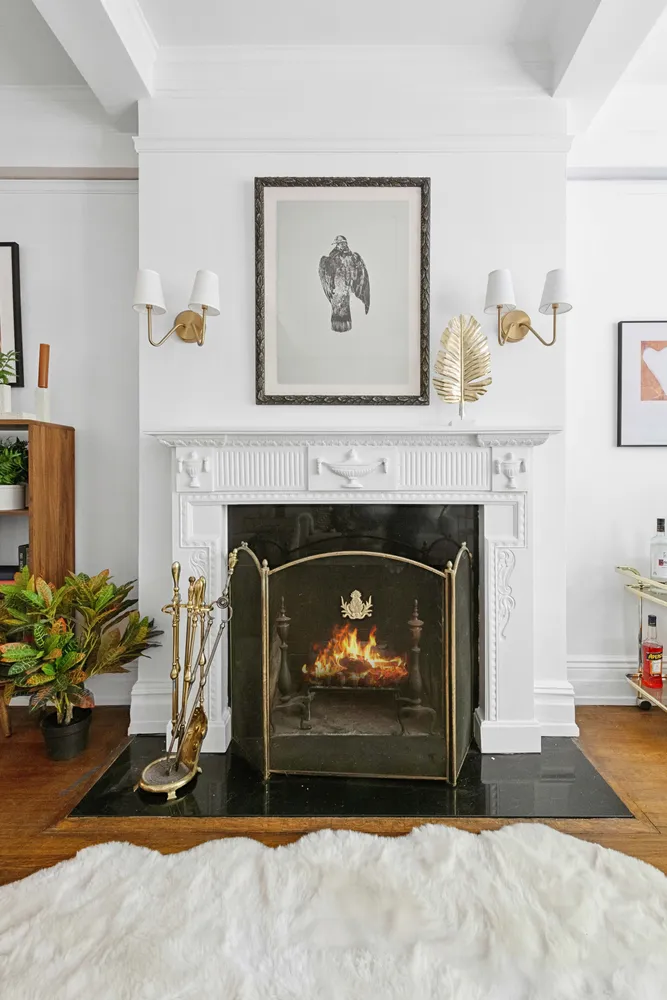 a living room with a fireplace and a potted plant