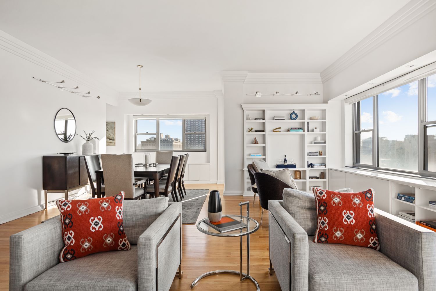 a living room with furniture kitchen view and a large window