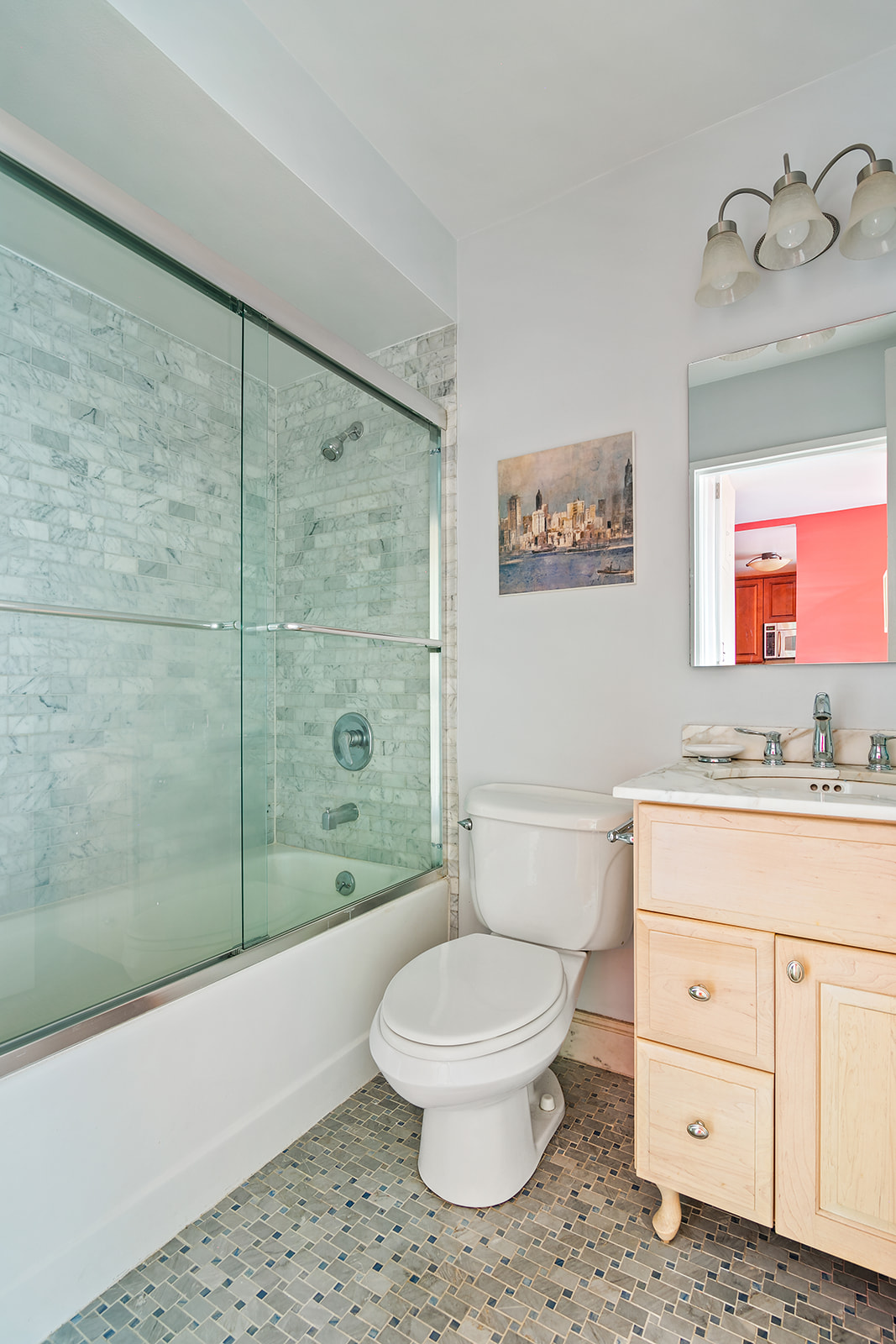 340 East 93rd Street, Unit 27K Manhattan, NY 10128 - Photo 5 of 12 a bathroom with a toilet a sink a mirror and shower