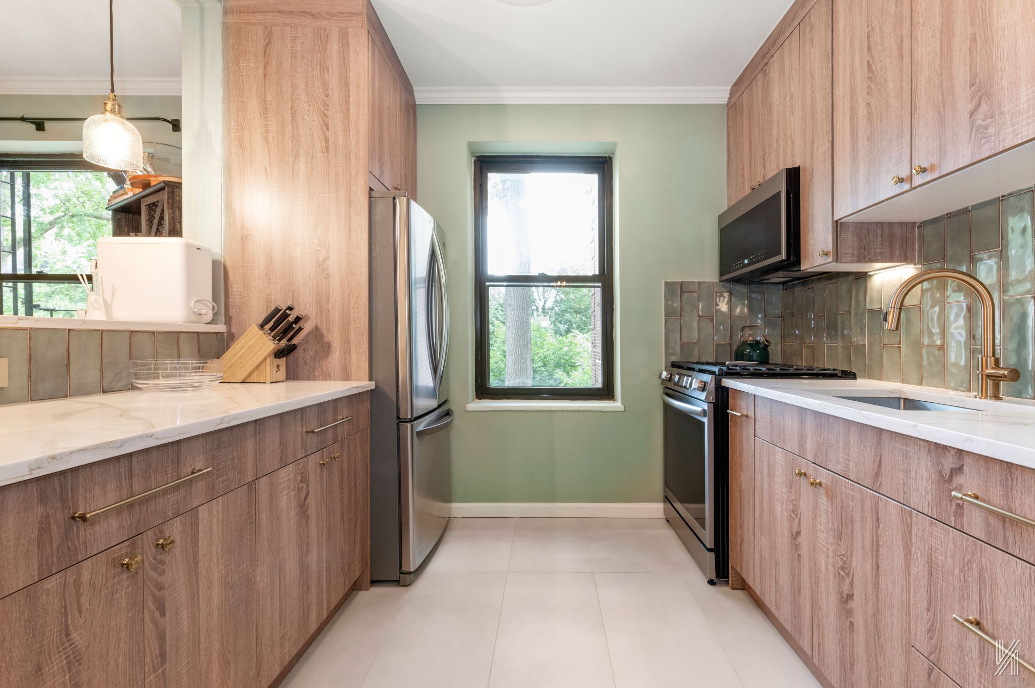 22-31 77th Street, Unit C2 Queens, NY 11370 - Photo 7 of 17 a kitchen with a sink stove and cabinets
